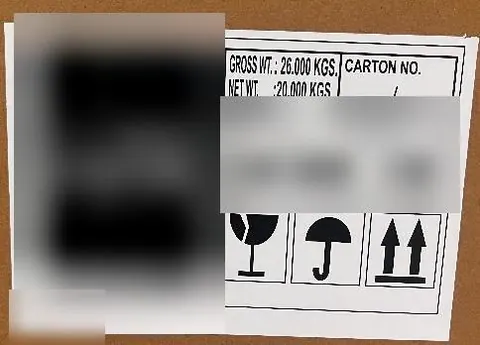 Shipping mark and handling symbols checked on an export carton, brand details blurred