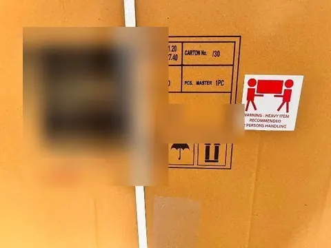 Shipping mark and handling label on an export carton, brand details blurred