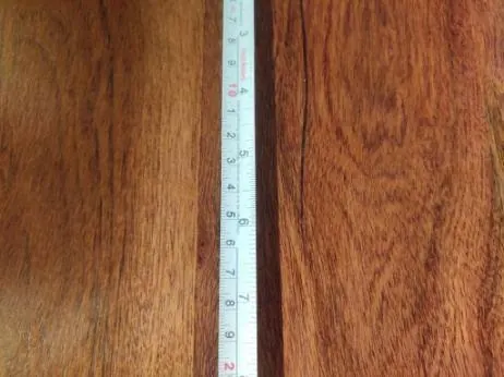 Major defect: end crack in a solid wood table top, measured against a tape