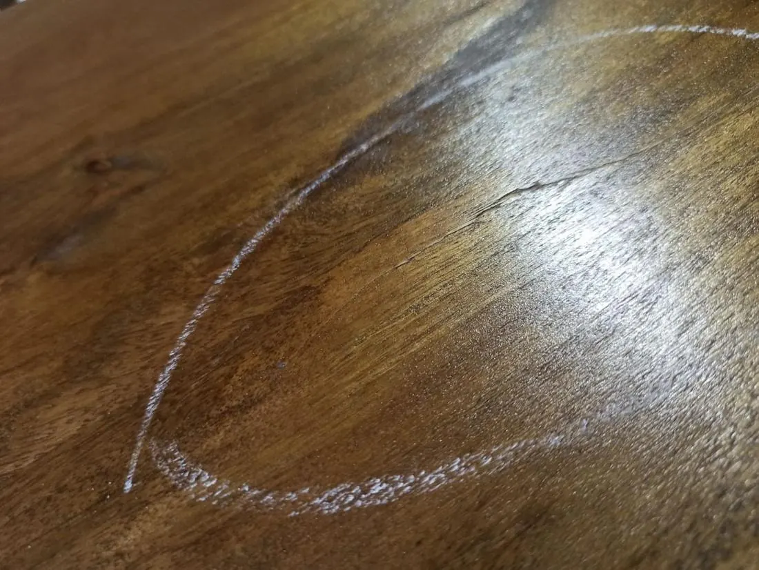 Major defect: crack in the wood of a cabinet, marked in chalk