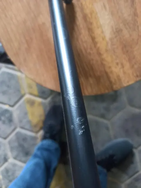 Minor defect: scratch on the iron stand of a sofa table
