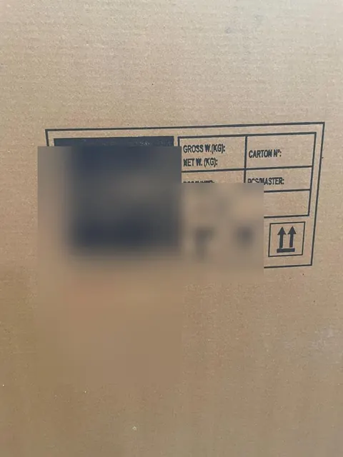 Shipping mark checked on a carton, brand blurred